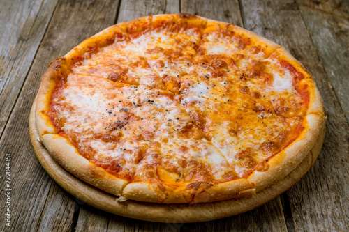 Italian pizza Margherita on wooden table