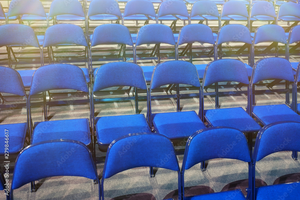 Naklejka premium Many blue chairs stand in a row before the event. Toned