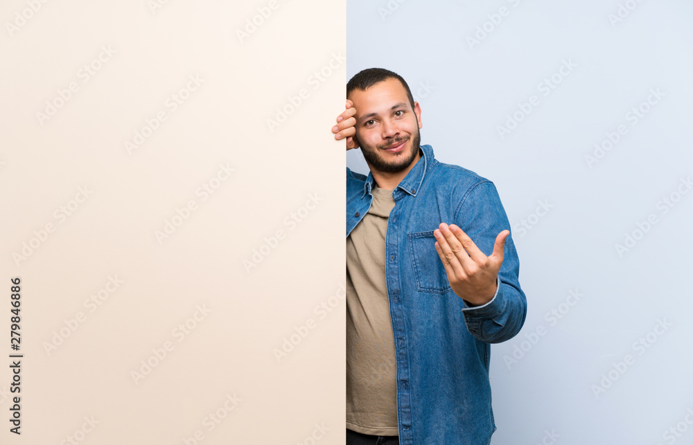 Colombian man holding an empty placard inviting to come Colombian man holding an empty placard inviting to come