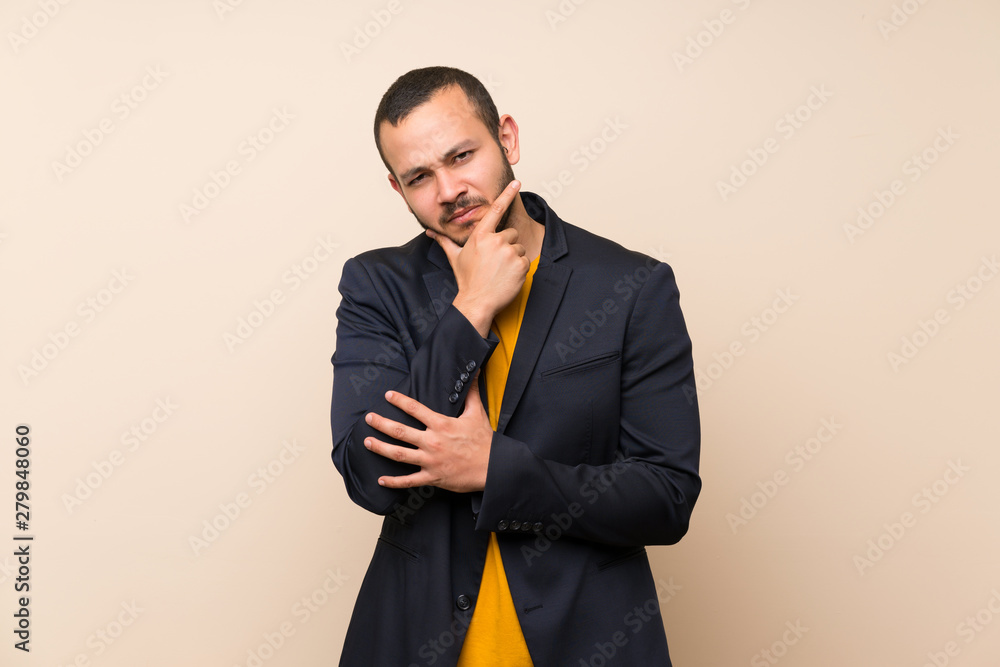 Colombian man over isolated background thinking an idea Colombian man over isolated background thinking an idea