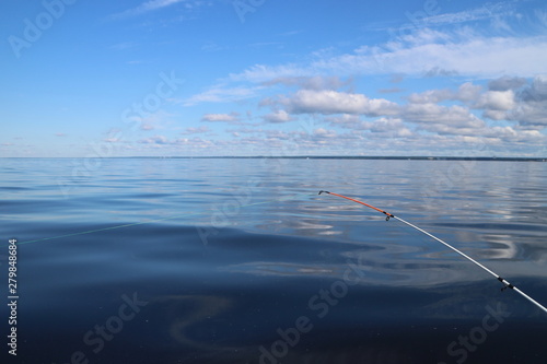 fishing on a quiet summer morning on the lake rod with fishing line stretched