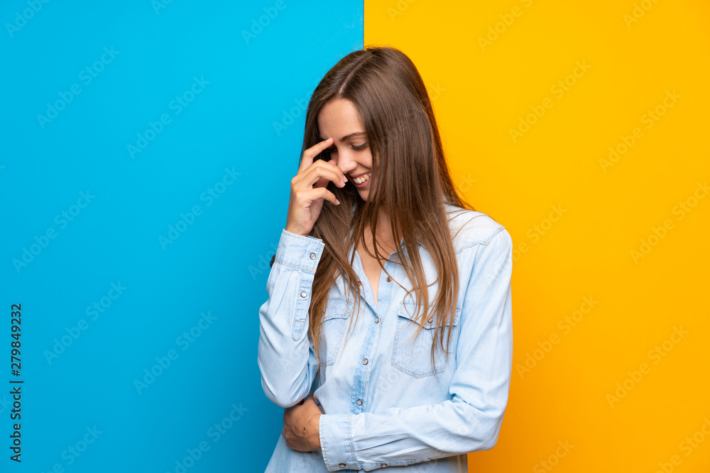 Young woman over colorful background laughing Young woman over colorful background laughing