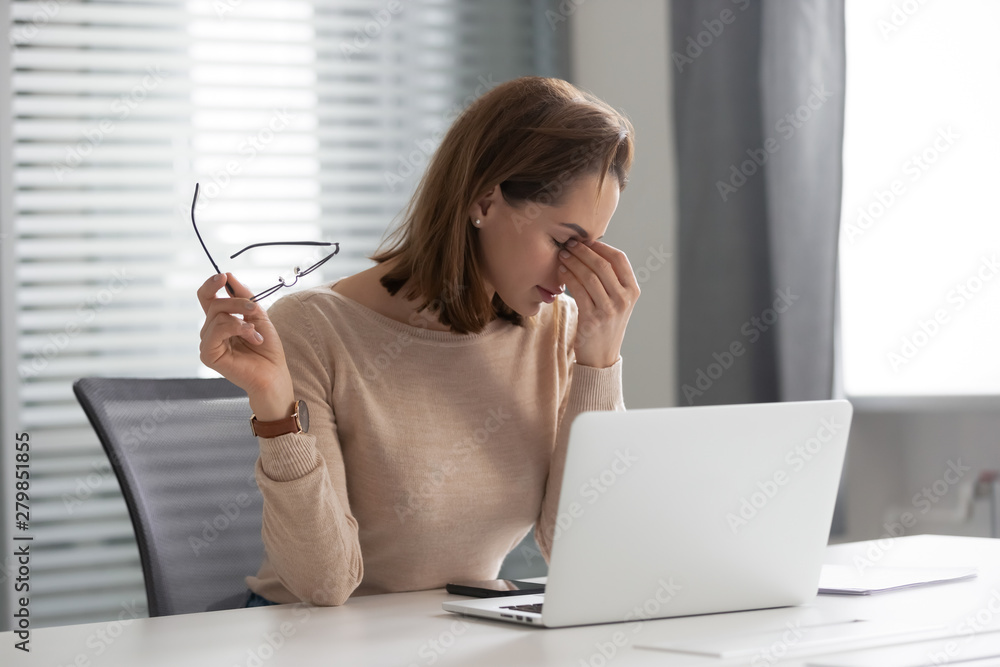 Obraz premium Fatigued stressed young businesswoman secretary feel eye strain at work