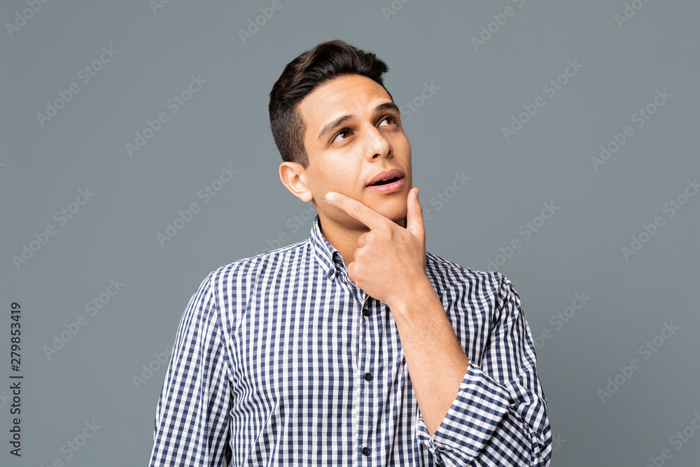 Mused and Pensive Man In Checkered Shirt Touching His Chin Mused and Pensive Man In Checkered Shirt Touching His Chin