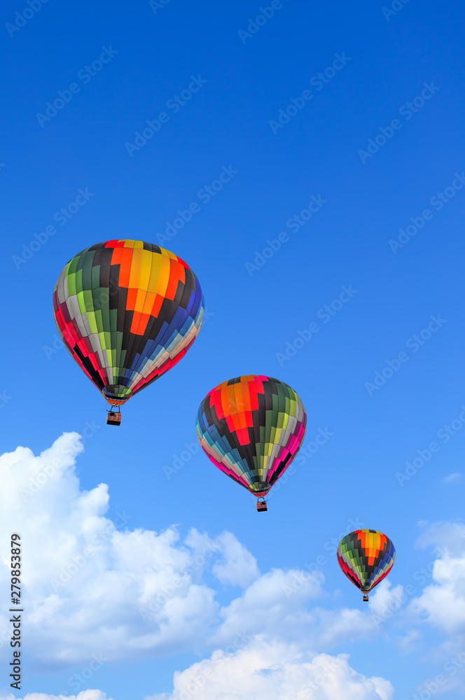 Obraz premium Colorful Hot Air Balloons in Flight over blue sky