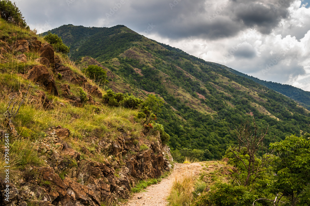 Mountain footpath through forest along the rocks. This is the path to the ruins of the medieval castle Maglic in Serbia.