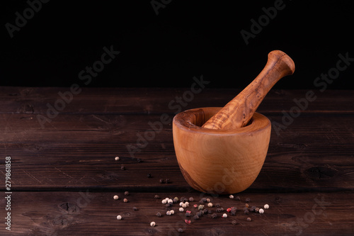 wooden mortar with pepper, low key, olive wood, rustic