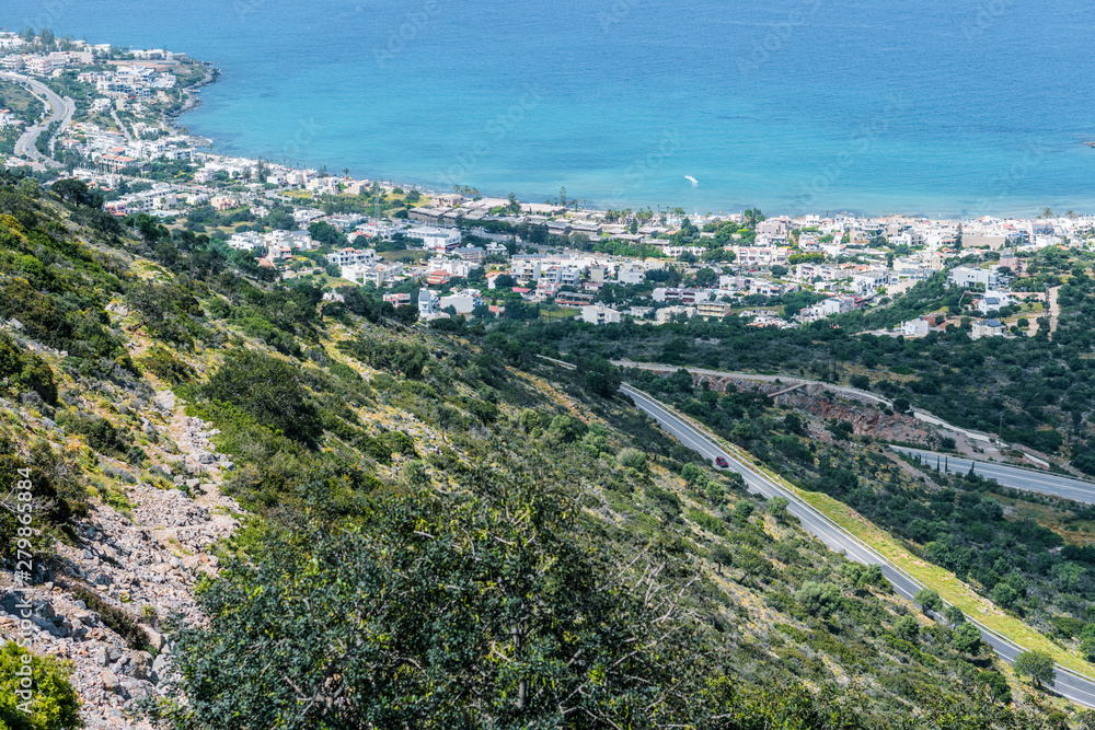 Top view from the mountains to the village of Malia, roads and the nearby villages of the field and the Aegean Sea. Crete, Greece