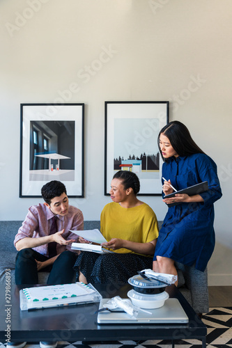 Three coworkers looking at paperwork