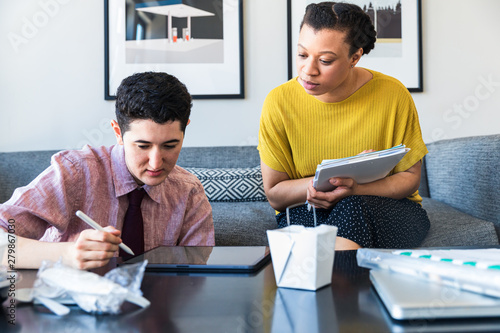 Young businessman and woman using tablet