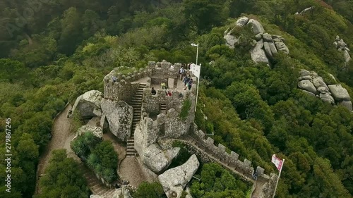 Aerial around view of Castelo dos Mouros or Moorish Castle, Moors in fog and clouds, Sintra, Portugal