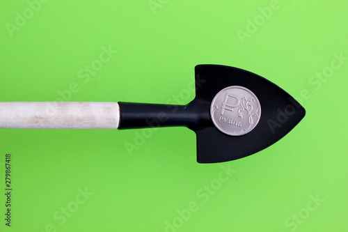money Russian rubles, metal coins 10 on a shovel, background, capital growth concept photo