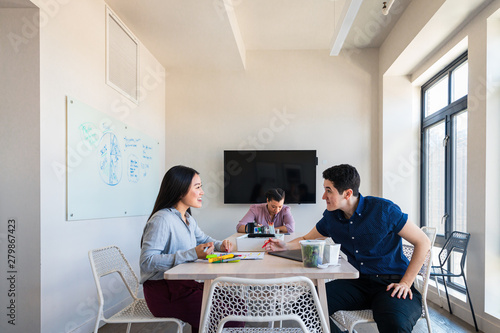 Three young coworkers in a meeting