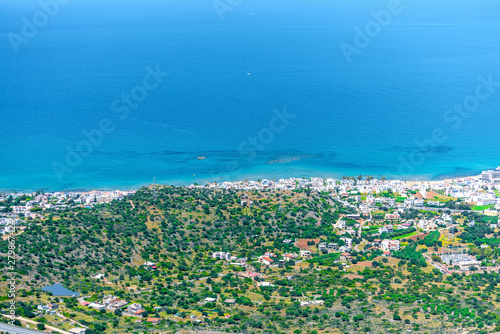 Top view from the mountains to the village of Malia, roads and the nearby villages of the field and the Aegean Sea. Crete, Greece © flowertiare