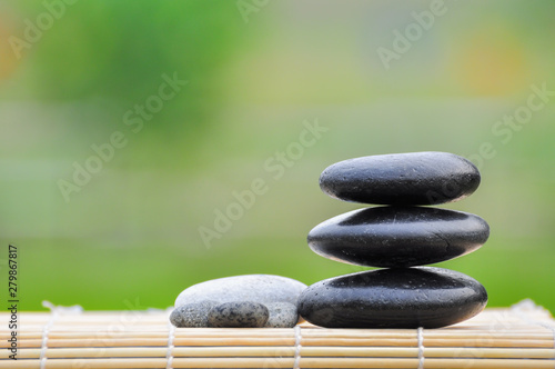 Pebble stones on nature bokeh background - SPA Concept