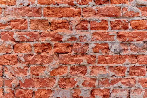 Simple photo background pattern of red broken bricks wall.
