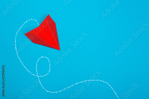 Red paper rockets or paper planes on a beautiful light blue background.