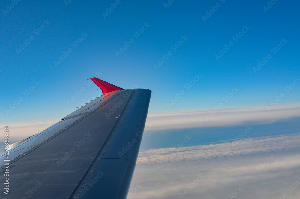 Flying and traveling, view from airplane window on the wing with copy space