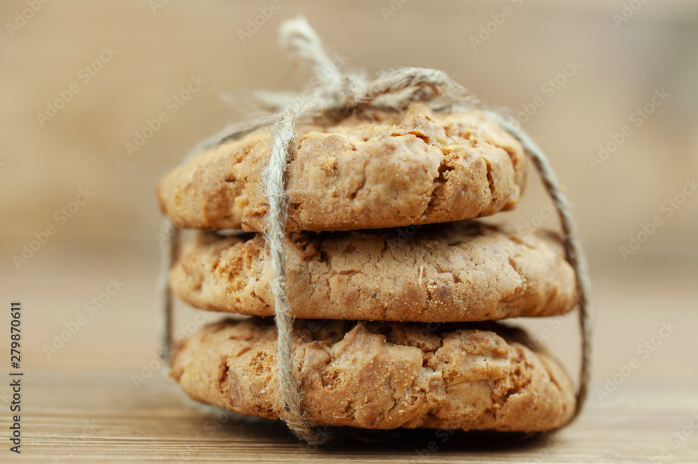 stack of cookies tied with a rope on a wooden background stack of cookies tied with a rope on a wooden background