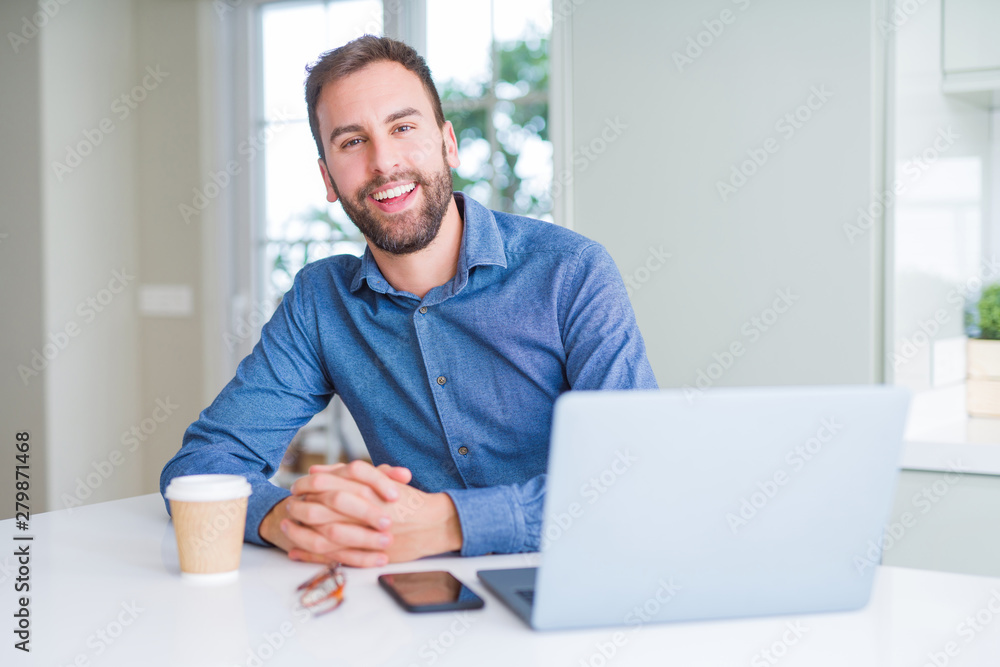 Handsome business man working using computer laptop and smiling Handsome business man working using computer laptop and smiling