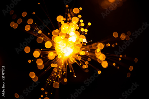 Fiber optic light abstract bokeh background with warm color. Out of focus.