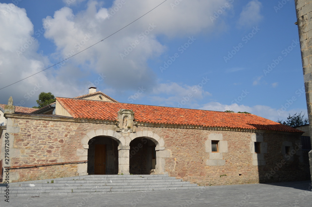 Fototapeta premium Facade Of The Pilgrims Hostel Next To The Church Of San Juan And Santa Basilisa In Island. August 27, 2013. Isla, Cantabria. Vacation Nature Street Photography.
