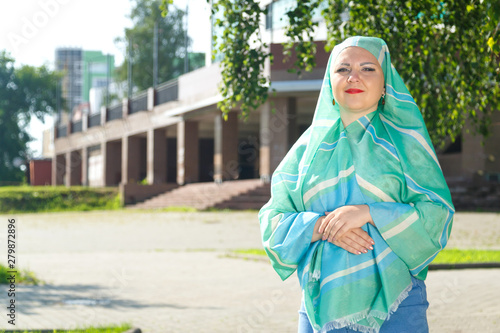 Young muslim woman in green hijab on the street. © finist_4