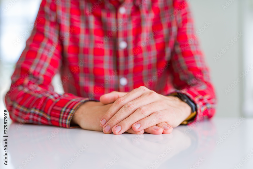 Close up of man hands with palms together over white table Close up of man hands with palms together over white table