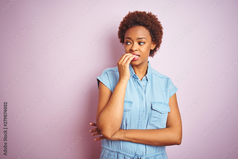 Young beautiful african american woman with afro hair over isolated pink background looking stressed and nervous with hands on mouth biting nails. Anxiety problem. Young beautiful african american woman with afro hair over isolated pink background looking stressed and nervous with hands on mouth biting nails. Anxiety problem.