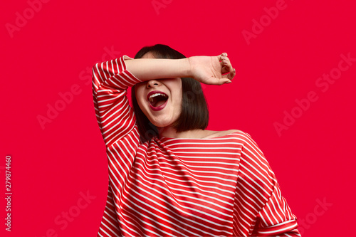 Exaggerated Asian woman covering eyes