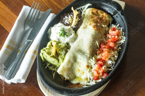 Mexican food: Burrito with avocado salad.