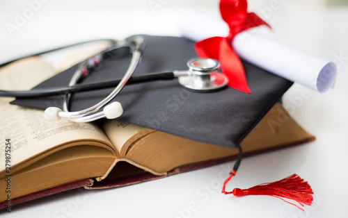 Black graduation cap, degree and stethoscope