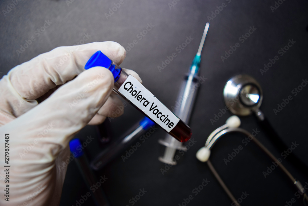 Cholera Vacine text with blood sample. Top view isolated on black background. Healthcare/Medical concept Cholera Vacine text with blood sample. Top view isolated on black background. Healthcare/Medical concept