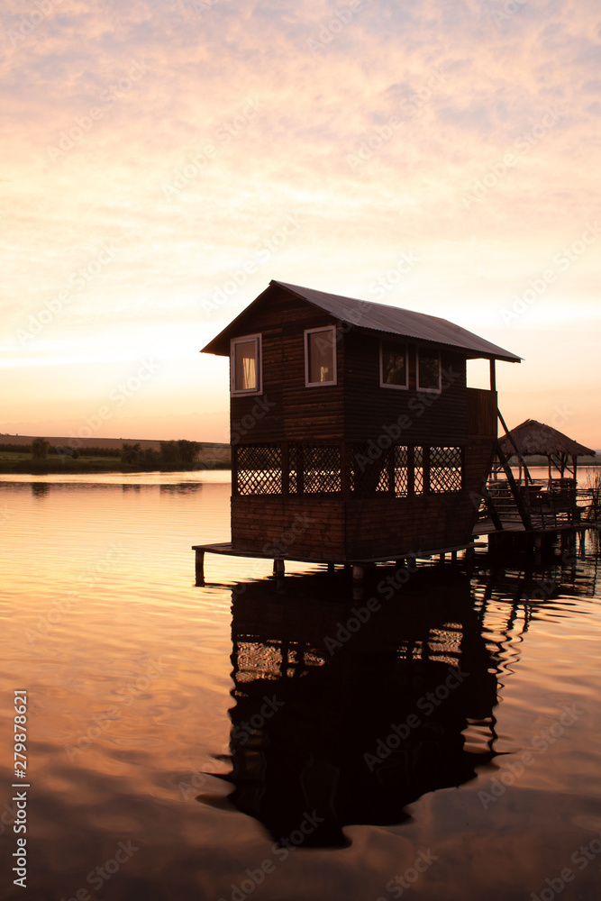 Summer wooden house on the water for recreation and fishing
