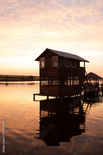 Summer wooden house on the water for recreation and fishing © Lyudmyla