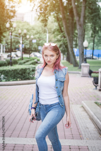 stylish hipster girl in denim clothes on a city street
