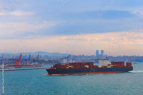 Large cargo container ship passing through Bosphorus, Istanbul, panorama of bosphorus