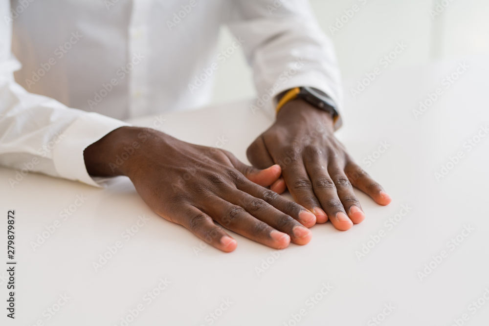 Obraz premium Close up of hands of african man over table