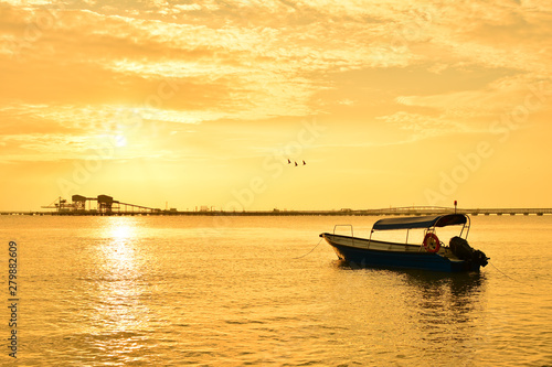 Fisherman boat with sunset background