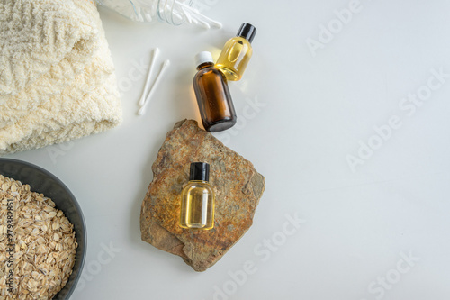 Top view of bottles with oats essential oil. Health care cosmetic products