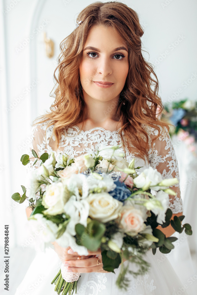 Beautiful bride in a wedding dress with lace, posing in the Studio Beautiful bride in a wedding dress with lace, posing in the Studio