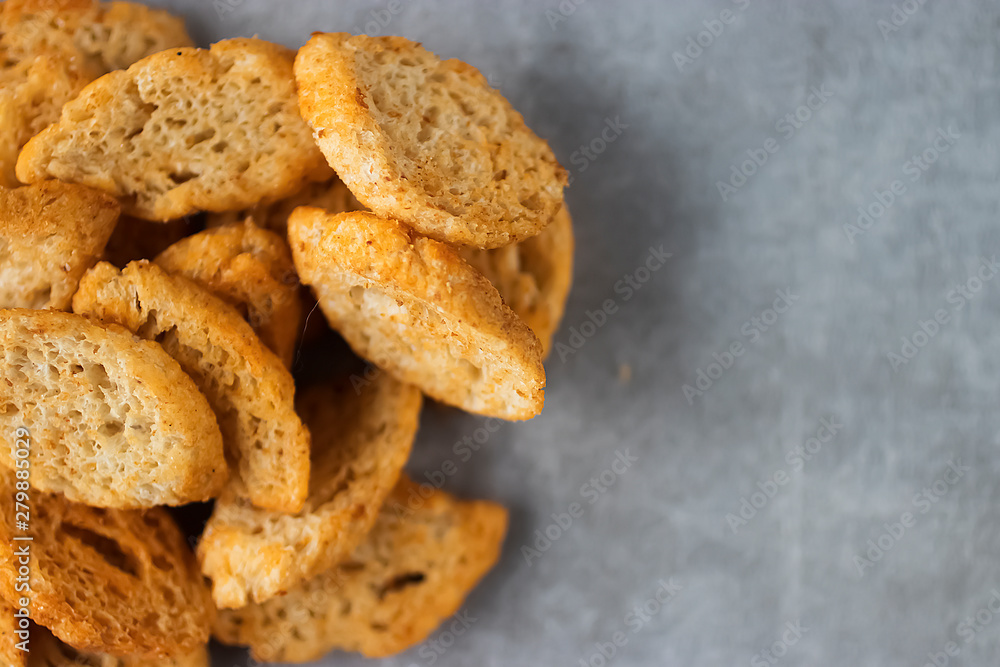 Wheat crackers on a gray background. Salty snack. Snack to beer. Wheat crackers on a gray background. Salty snack. Snack to beer.