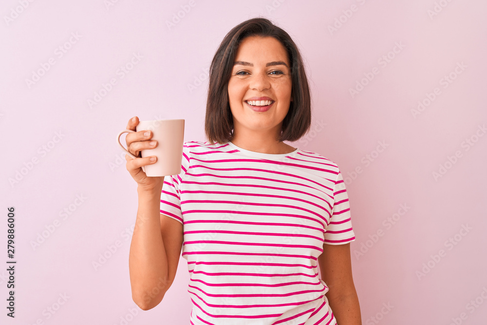 Young beautiful woman drinking cup of coffee standing over isolated pink background with a happy face standing and smiling with a confident smile showing teeth Young beautiful woman drinking cup of coffee standing over isolated pink background with a happy face standing and smiling with a confident smile showing teeth