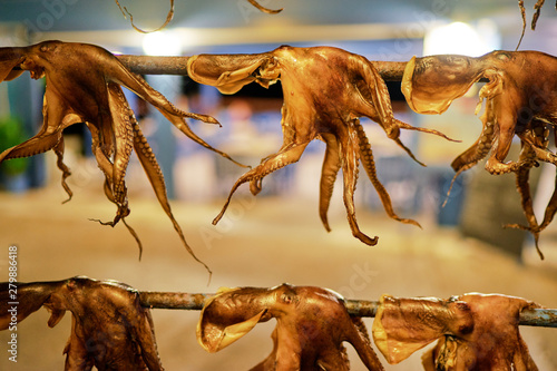 Fototapeta Naklejka Na Ścianę i Meble -  Octopus tentacles dried in a Greek tavern on the street in Greece.