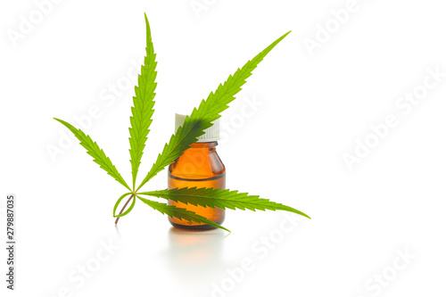 Marijuana cannabis leaf and cannabis oil extract in jar.