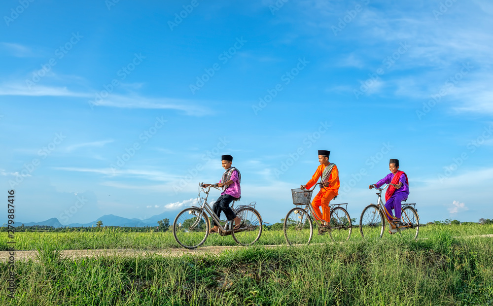 happy young local boy riding old bicycle at paddy field happy young local boy riding old bicycle at paddy field