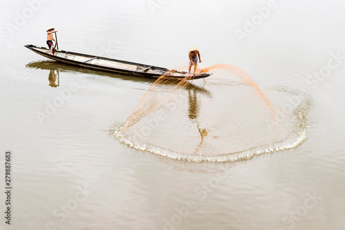 Net casting fishermen on the Perfume River, Hue, Vietnam photo