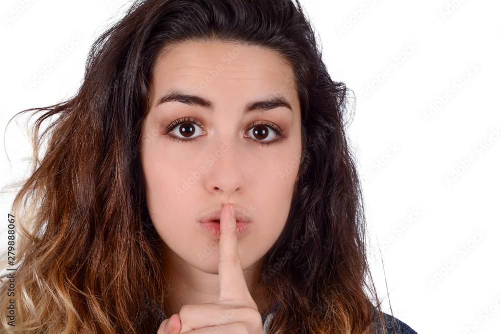 Close up of young woman making silence gesture. Close up of young woman making silence gesture.