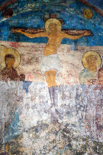 Photo of the old fresco crucifix of Christ on the wall © tanor27