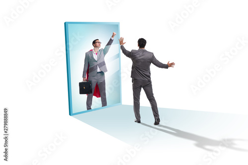 Businessman seeing himself in mirror as superhero © Elnur